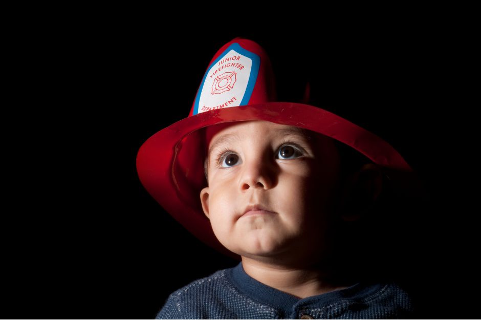 child with firefighter helmet